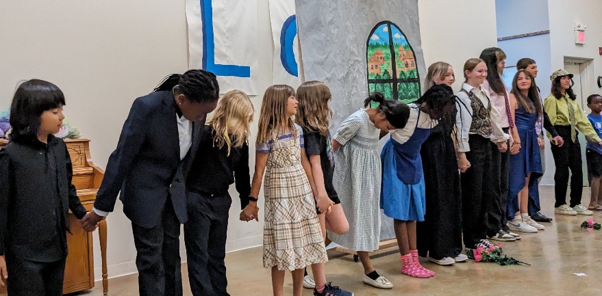 A group of people standing in a line

AI-generated content may be incorrect.