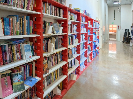 A row of red shelves with books

AI-generated content may be incorrect.